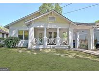 Charming home with a spacious front yard and inviting covered porch and a porte-cochere at 78 Atlanta Se Ave, Atlanta, GA 30315