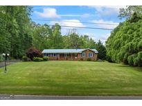 Charming single-story home with a well-manicured lawn and lush landscaping at 725 & 761 School Road, Hampton, GA 30228