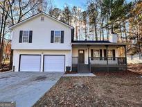 Charming split-level home with a covered front porch and two-car garage at 473 Amy Blvd, Temple, GA 30179