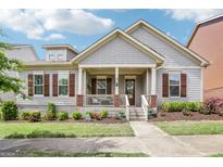 Charming home featuring a welcoming front porch, well-manicured landscaping, and classic architectural details at 175 Campaign Trl, Fayetteville, GA 30214
