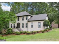 Charming two-story home with a landscaped yard and welcoming front entrance with gray roof and trim at 2819 Saddlebrook Nw Way, Marietta, GA 30064