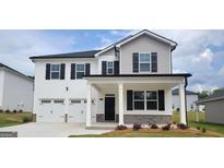 Charming two-story home with white siding, black shutters, and a two-car garage showcasing modern curb appeal at 146 Oakchase Park Lane, Hampton, GA 30228