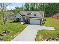 Charming single-Gathering home with manicured lawn, beautiful landscaping, and a two car garage at 2124 Gaddis Rd, Canton, GA 30115