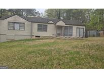 Quaint single-story home with a spacious front yard, showing its potential for landscaping at 4064 Sunset Sw Dr, Atlanta, GA 30331