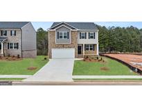Charming two-story home with a two-car garage and manicured front lawn at 588 Whitman Ln # 23, Stockbridge, GA 30281