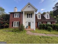 Two story home featuring a brick and vinyl exterior with a front entrance framed by columns at 11 Lakeview Ln, Stockbridge, GA 30281