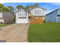 Charming home with a deck, garage, and lush lawn at 4811 Nevilly Way, Marietta, GA 30066
