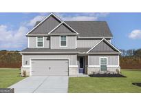 Charming two-story home featuring a two-car garage and a well-manicured lawn at 412 Cantrell Drive, Dallas, GA 30157