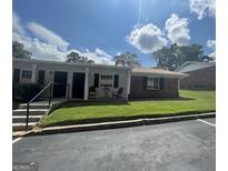 Charming one-story home with brick and gray facade, quaint front porch, and manicured lawn at 140 Se Mount Zion Rd # 41, Atlanta, GA 30354