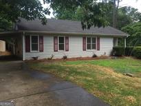 Charming single story home with red shutters and a well manicured front yard at 3875 Grand Prix St, Cumming, GA 30041