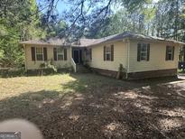 Ranch-style home with charming shutters and ample yard space, awaiting your personal touch at 30 Woodfield Rd, Covington, GA 30014
