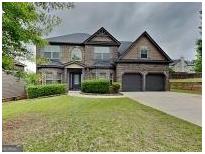 Charming brick two-story home with well-manicured lawn and two-car garage in suburban community at 305 Mango Ct, Mcdonough, GA 30253