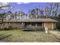 Charming single-story brick home featuring a convenient access ramp and attached one car garage at 2807 Knollview Dr, Decatur, GA 30034