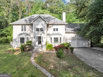 Beautiful home featuring a well-manicured front lawn and charming walkway to a covered front porch at 5045 Rock Springs Rd, Lithonia, GA 30038