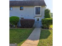 Charming townhome with manicured front yard and inviting walkway at 288 Country Club Dr, Jonesboro, GA 30238