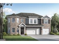 Traditional two-story brick home with a three-car garage and well-manicured lawn at 1205 Trombone Way # 3, Mcdonough, GA 30252