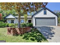 Charming home with white siding, dark trim, and a well-manicured front yard at 3336 Country Creek Nw Dr, Kennesaw, GA 30152