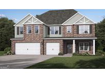Beautiful two-story home boasting a brick facade, two-car garage, and a well-manicured lawn at 799 Grande Bishop Dr, Fairburn, GA 30213