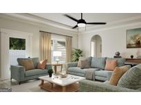 Cozy living room with comfortable seating, ceiling fan, and a bright, neutral color palette at 799 Grande Bishop Dr, Fairburn, GA 30213