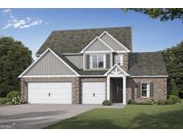 Two-story brick home with a two-car garage, gabled roof, and beautifully landscaped front yard at 782 Grande Bishop Dr, Fairburn, GA 30213