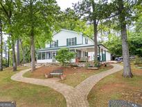 Charming two-story home with a brick walkway and inviting screened-in porch at 2000 Campbell Rd, Covington, GA 30014