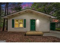 Cozy, one-story home featuring green door and shutters, plus a small, covered front porch at 3118 Rockbridge Rd, Avondale Estates, GA 30002