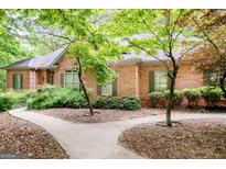 Charming brick home featuring a well-maintained lawn and mature trees at 260 Emerald Lake Dr, Fayetteville, GA 30215