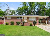 Charming single-story brick home featuring a well-manicured lawn and convenient carport at 322 E Rhinehill Rd, Atlanta, GA 30315