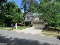 Charming two-story home featuring a stone and siding facade, manicured lawn, and attached two-car garage at 4832 Batiste, Acworth, GA 30101