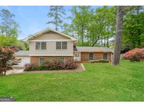 Charming two-story home with brick accents, lush landscaping, and a well-maintained lawn at 543 Tahoe Cir, Stone Mountain, GA 30083