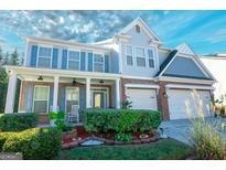 Charming two-story home boasts a well-manicured lawn and inviting curb appeal at 1017 Preserve Park Dr, Loganville, GA 30052