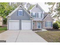 Charming two-story home features a two car garage, stone accents, and craftsman details at 3313 Bethesda Ter, Acworth, GA 30101