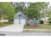 Charming two-story home featuring a stone facade, gray siding, well-maintained lawn, and a two car garage at 3313 Bethesda Ter, Acworth, GA 30101