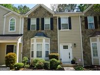 Charming townhome with stone accents, neat landscaping and a welcoming front door at 2566 Summit Cove Dr, Duluth, GA 30097