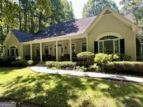 Charming one-story home with a covered front porch and well-maintained landscaping at 3644 Graycliff Rd, Snellville, GA 30039