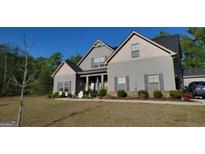Charming gray two-story home featuring well-maintained landscaping and a welcoming front porch at 101 Ruby Ln, Mcdonough, GA 30252