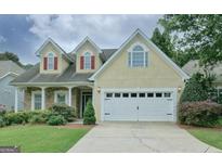 Charming two-story home featuring a two-car garage and a well-maintained landscaped front yard at 834 Chalet Hills, Mcdonough, GA 30253