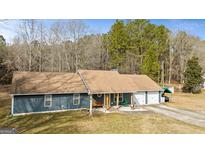 Charming single-story home with a well-maintained yard and an attached two-car garage at 105 Meadow Spring'S Ct, Locust Grove, GA 30248