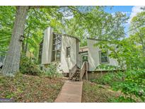 Stunning contemporary home featuring unique architectural details and mature landscaping at 1213 Laurel Cliff Se Dr, Smyrna, GA 30082