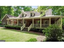 Charming brick home with a welcoming front porch and manicured lawn at 31 Butler Bridge Dr, Mcdonough, GA 30252