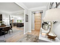 Inviting entryway showcasing an open floor plan with a dining room and living room at 109 Old Virginia Cir, Jonesboro, GA 30236