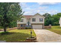 Charming two-story home with well-maintained lawn, stone accents, and inviting curb appeal at 227 River Trace Ct, Mcdonough, GA 30253