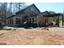 Inviting home with a covered patio, grill, and outdoor seating perfect for entertaining at 460 Morgan Mill Rd, Brooks, GA 30205