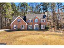 Charming two-story brick home with classic shutters and a well-manicured front yard at 212 Birkhill, Peachtree City, GA 30269