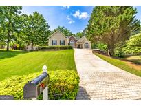 Traditional home with well-maintained landscaping, charming curb appeal, and a long driveway leading to the residence at 120 Lyndhurst Way, Sharpsburg, GA 30277