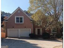 Charming brick home featuring a two-car garage and a meticulously maintained front yard at 4746 Chamblee Dunwoody Rd, Atlanta, GA 30338