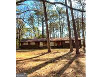 Charming single-story home nestled among the trees, offering a serene and private setting at 4212 Moore Rd, Conley, GA 30288