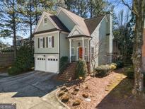 Charming home featuring a brick staircase, red front door, and two-car garage at 5 Renfroe Ct, Decatur, GA 30030