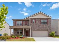 Charming brick two-story home featuring a covered porch and a two-car garage at 5396 Pennington Ct, South Fulton, GA 30349