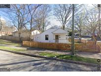Charming craftsman-style home with a welcoming front porch and a well-maintained fenced yard at 1267 Lyle Nw Pl, Atlanta, GA 30318